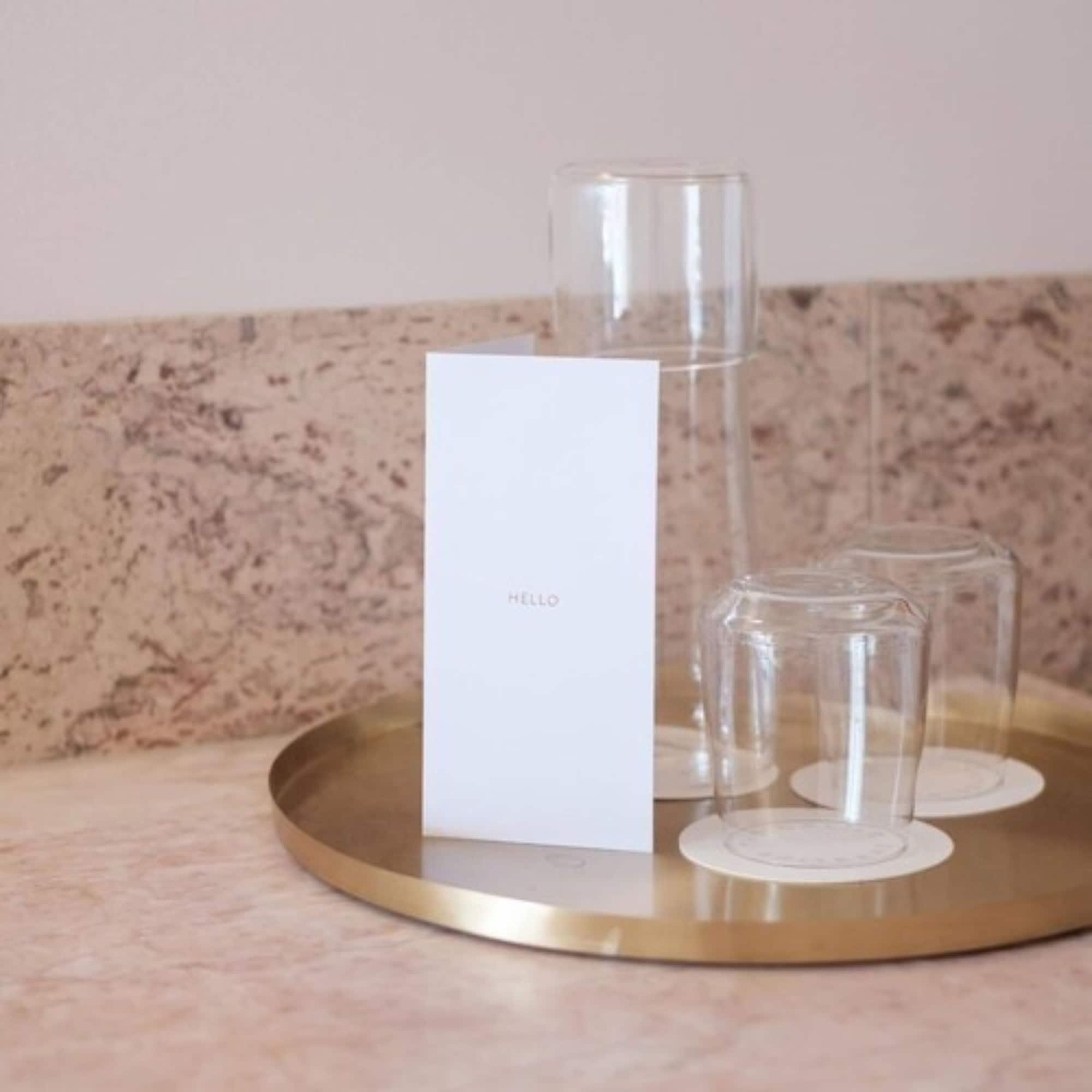 The Calile Hotel Brisbane Exterior photo A tray of water and glasses at a hotel